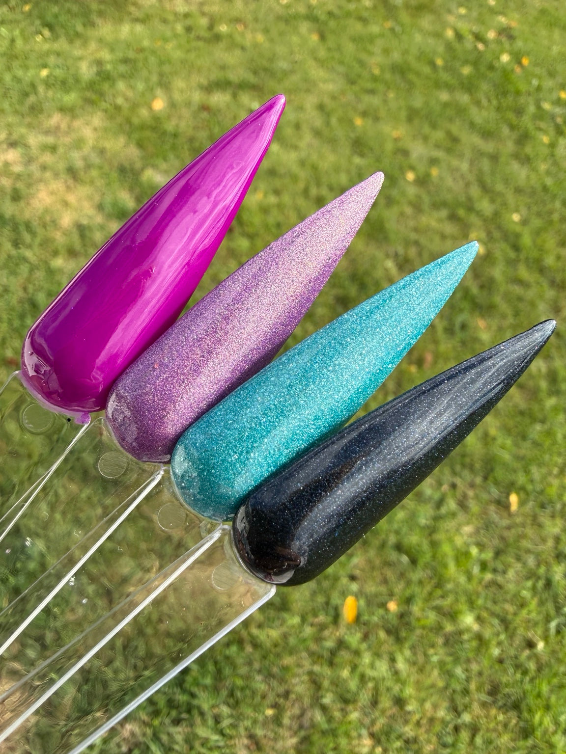 Outdoor photo of all four dip powder shades