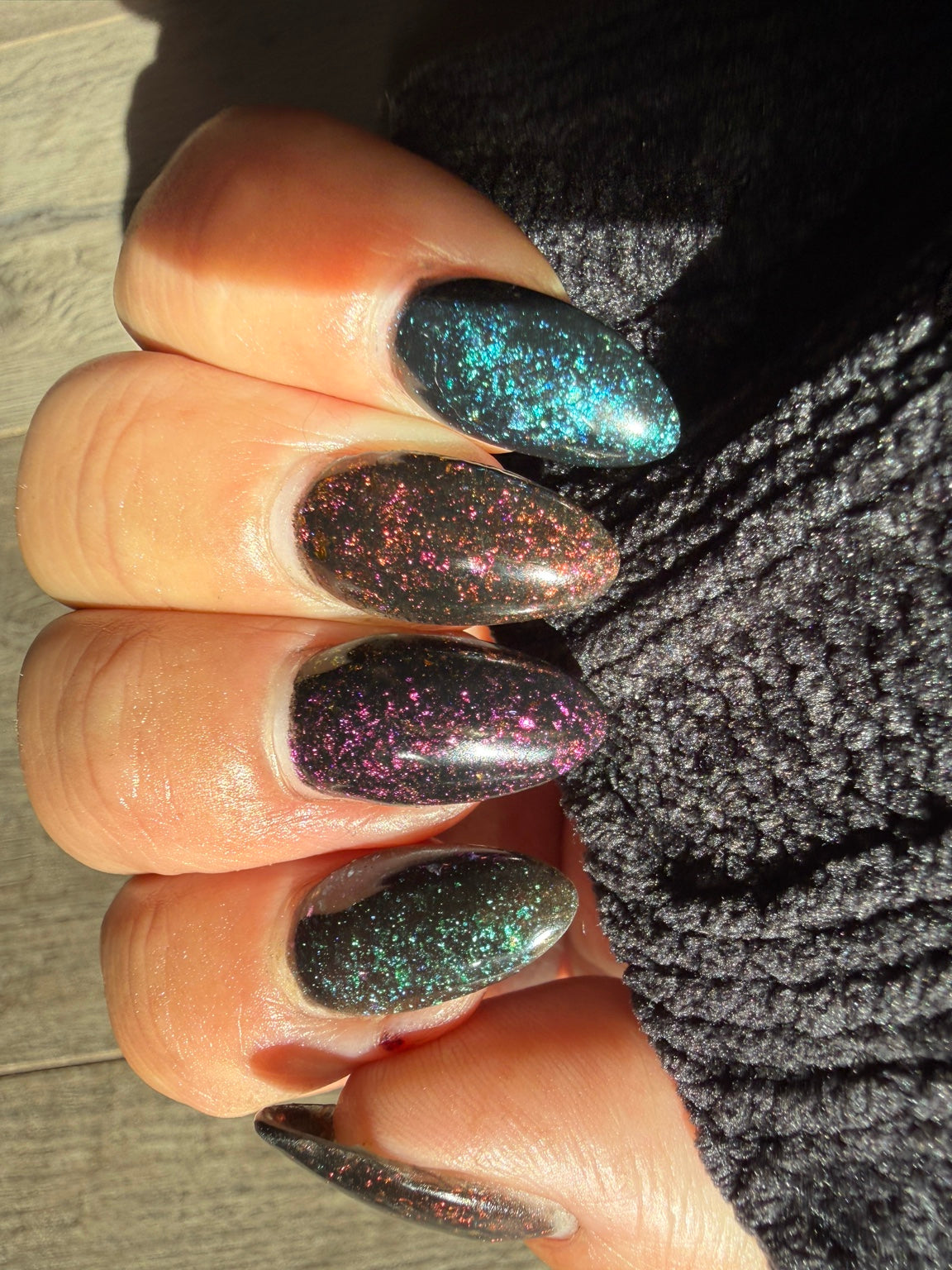 Black chameleon flake manicure featuring After Hours, natural-light view 3