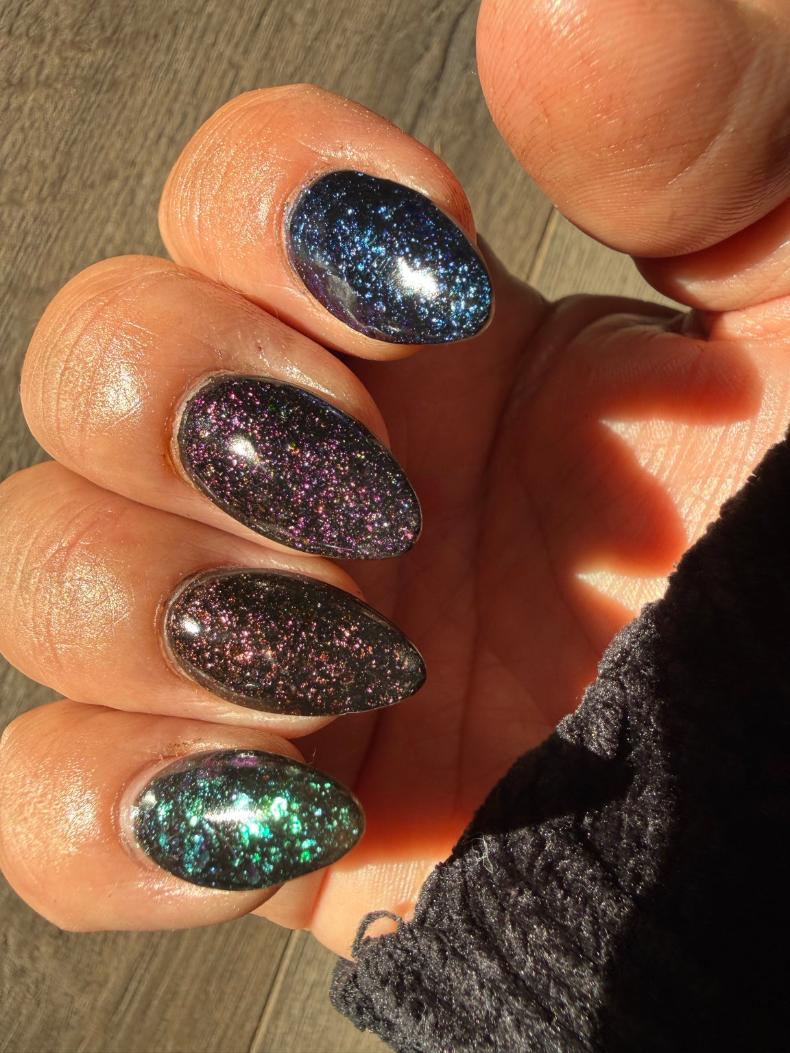Black chameleon flake manicure featuring Zero Regrets, natural-light view 4