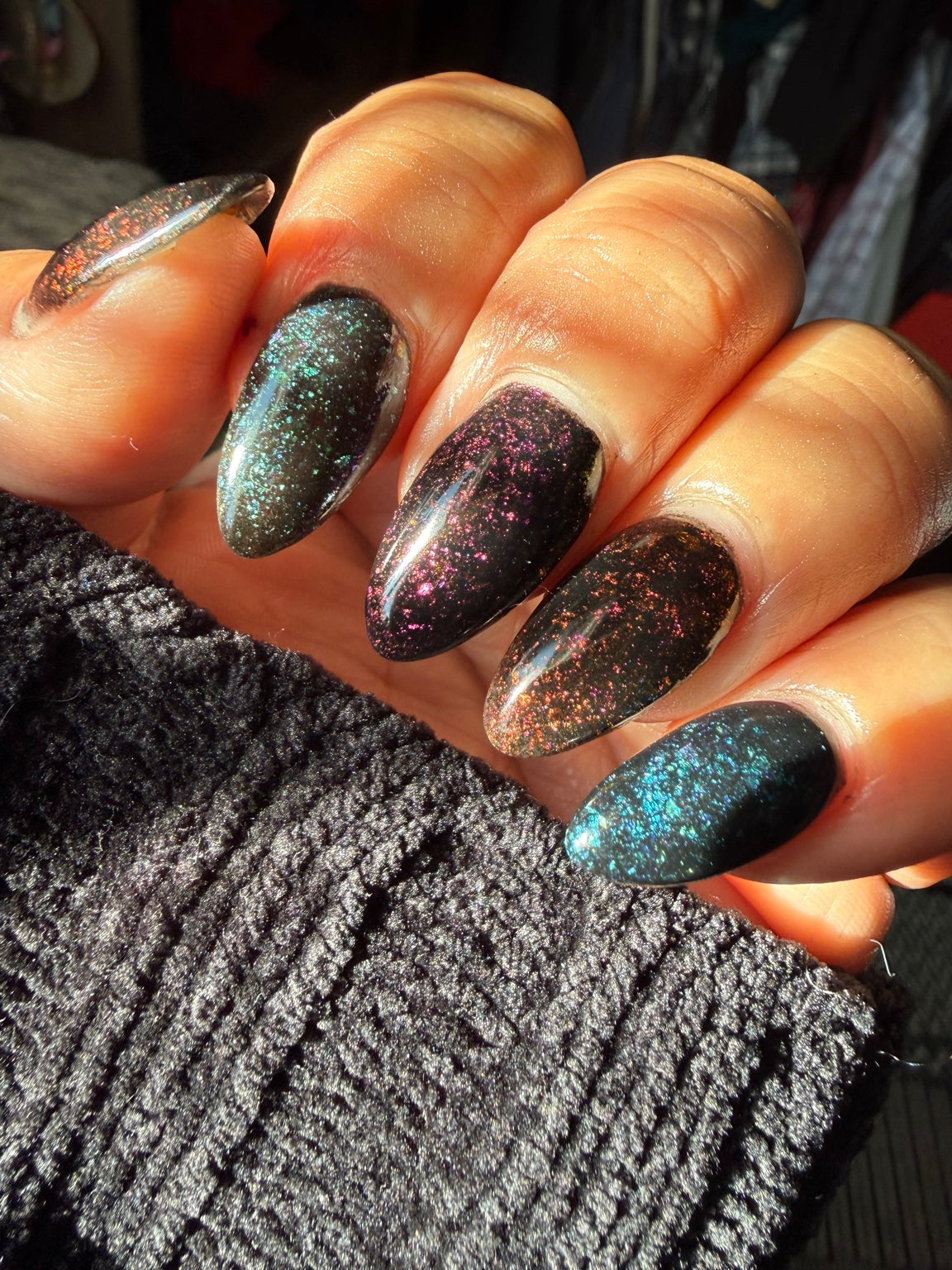 Full-hand black chameleon flake manicure featuring Playing With Fire