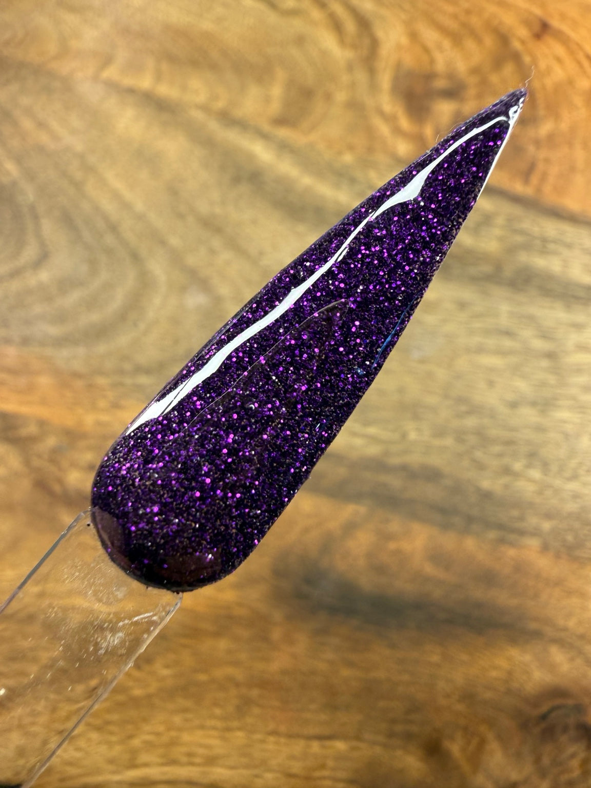 Hex Appeal deep purple glitter dip powder swatch on wood background