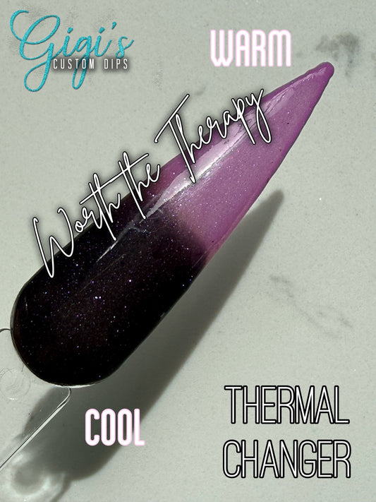 Labeled Worth the Therapy thermal dip powder swatch showing cool near-black plum and warm lilac pink